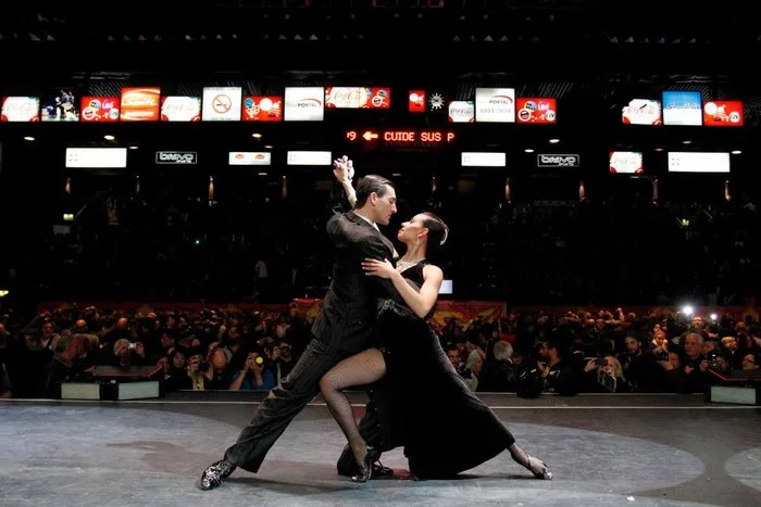 Tango pora atlieka plačią sceninę figūrą prieš publiką Buenos Airėse.