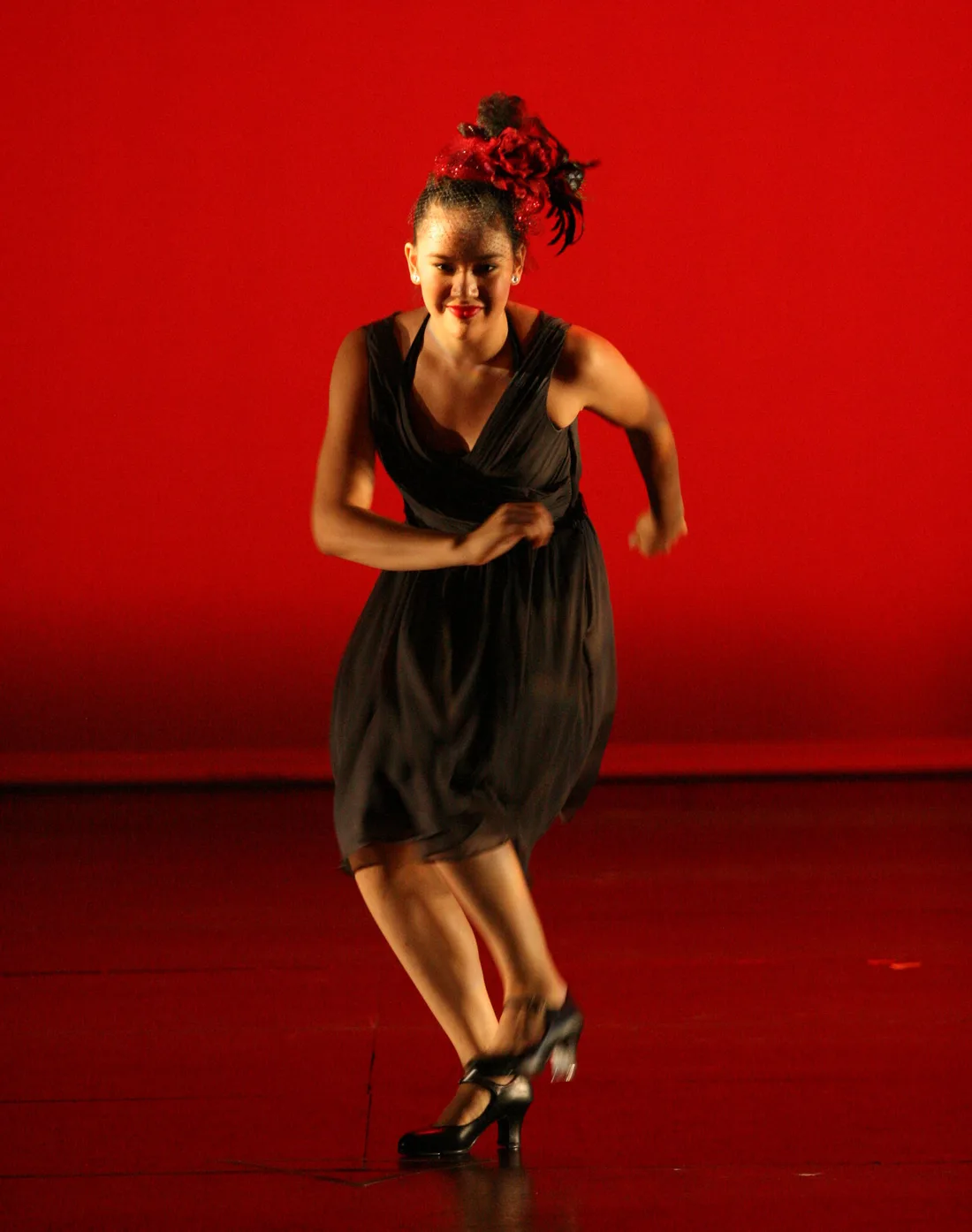 Daria L. performs tap dance on stage.